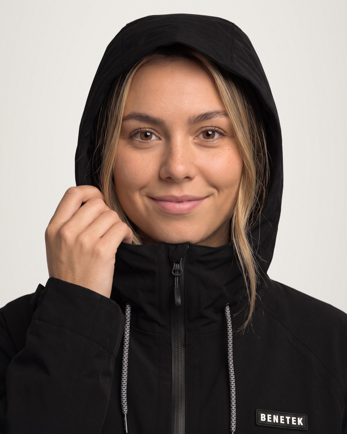 Sarah in the black Focus Jacket, hood up